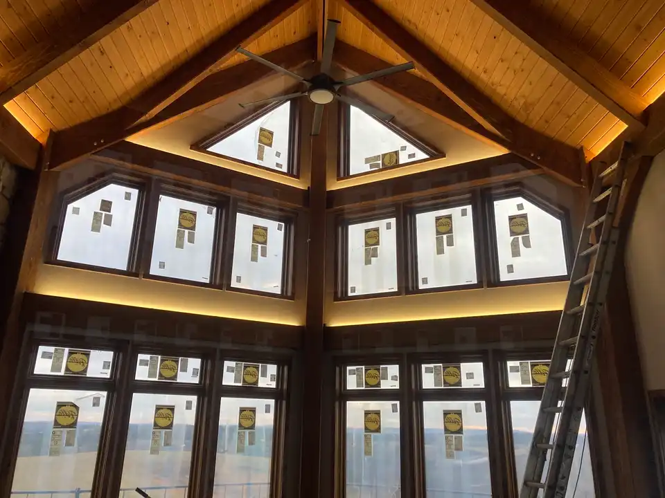 A great room window wall with warm LED cove lighting above and below the glass, installed by Pro Phase Electric