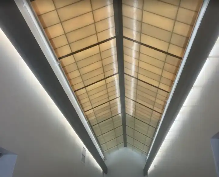 A long skylight-style ceiling panel edged with LED strip lighting