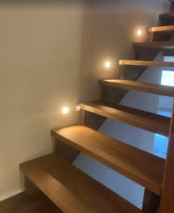 Open wood stair treads with small step lights